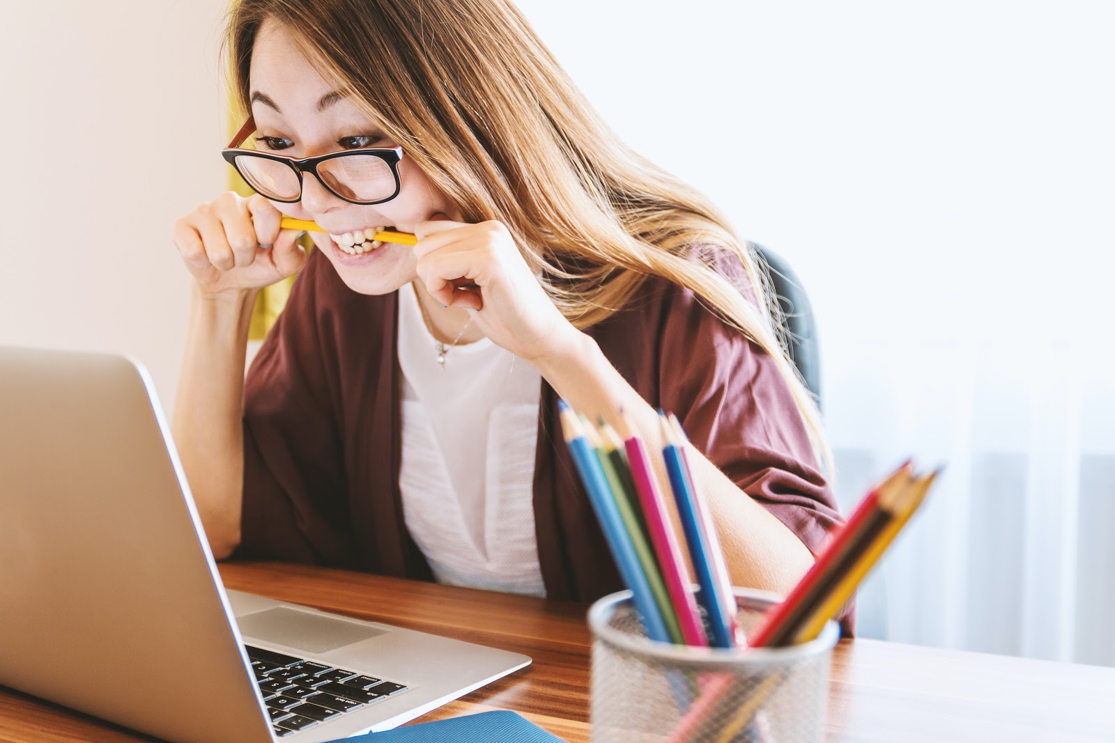 Stressed woman working remotely at her desk, highlighting challenges of remote work productivity.